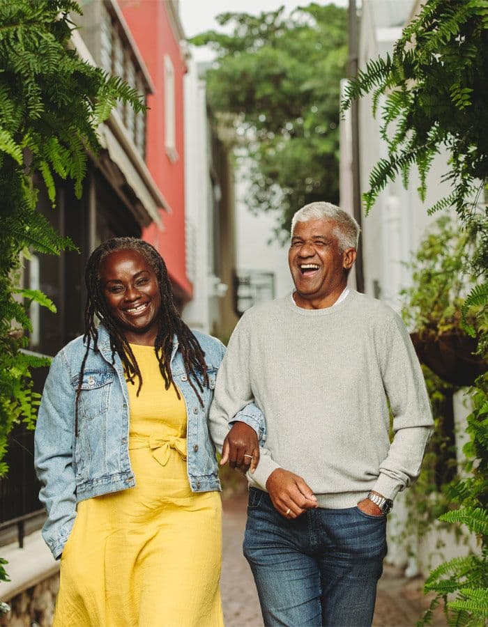 Smiling couple walking down a city street